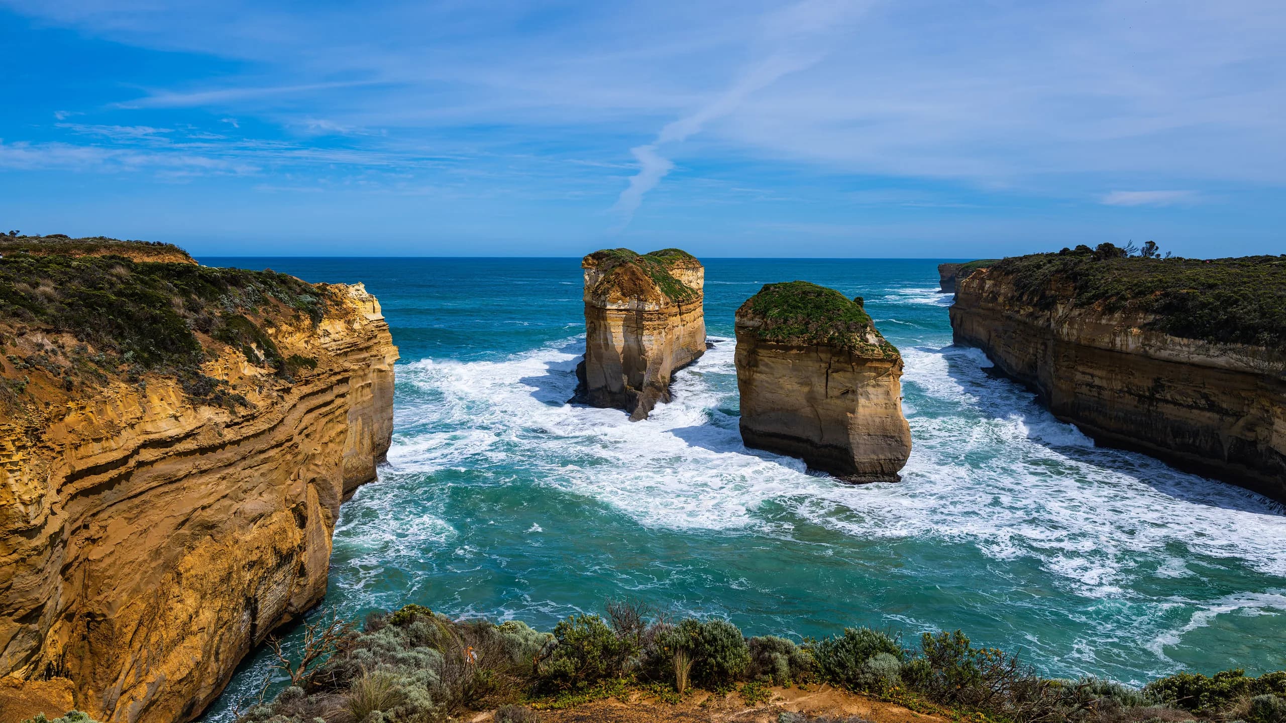 Limestone stacks and sandstone cliffs above turquoise surf on the Shipwreck Coast, near Loch Ard Gorge